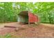 The metal outbuilding provides extra storage space and functionality on the property at 132 Homeplace Ln, Statesville, NC 28625