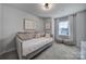 Inviting bedroom with daybed, pillows, window, and modern decor at 149 Briana Marie Way, Indian Trail, NC 28079