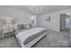 Well-lit bedroom features neutral tones, carpet, and a modern chandelier at 149 Briana Marie Way, Indian Trail, NC 28079