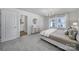 Bedroom with carpet, neutral tones, modern chandelier, and view of the ensuite bathroom at 149 Briana Marie Way, Indian Trail, NC 28079