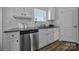 Well-lit kitchen featuring modern appliances, granite countertops, and sleek white cabinetry at 149 Briana Marie Way, Indian Trail, NC 28079