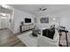 Bright living room with modern decor, ceiling fan, and wood-look floors at 149 Briana Marie Way, Indian Trail, NC 28079