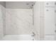 Clean bathroom showcasing marble tiled shower and tub combination with tiled walls and modern fixtures at 1525 16Th Avenue Nw Cir, Hickory, NC 28601