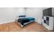 Bedroom with wood-look vinyl floors, queen sized bed and white storage cabinet at 1525 16Th Avenue Nw Cir, Hickory, NC 28601