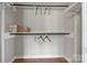 Simple, walk-in closet featuring wooden floor, shelves and a black clothes-hanging pole at 1525 16Th Avenue Nw Cir, Hickory, NC 28601