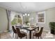 Elegant dining room featuring a stylish table, six chairs, natural light, and sliding door access to outdoor space at 1525 16Th Avenue Nw Cir, Hickory, NC 28601