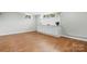 Large room with vinyl flooring, featuring a white built-in storage and display center and white walls at 1525 16Th Avenue Nw Cir, Hickory, NC 28601