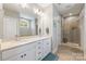 Bathroom featuring dual sinks, a walk-in shower, and ceramic tile floors at 1620 Arnold Dr, Charlotte, NC 28205