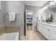 Bathroom with double vanity, tile floors, and doorway view to bedroom at 1620 Arnold Dr, Charlotte, NC 28205