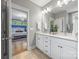 Bathroom with double vanity, tile floors, and doorway view to Primary bedroom at 1620 Arnold Dr, Charlotte, NC 28205