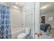 Bathroom featuring tub with blue patterned curtain, toilet and view into bedroom with closet at 1620 Arnold Dr, Charlotte, NC 28205