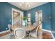Dining room with a round table, stylish chandelier, and open doorway to a staircase and another room at 1620 Arnold Dr, Charlotte, NC 28205