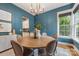 Bright dining room featuring a round wood table, stylish chandelier, and large window with natural light at 1620 Arnold Dr, Charlotte, NC 28205
