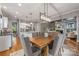 Dining area featuring a wood table, chandelier, and a view of the kitchen and living area at 1620 Arnold Dr, Charlotte, NC 28205
