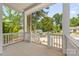 Inviting porch view with white pillars and railings overlooking the quiet street at 1620 Arnold Dr, Charlotte, NC 28205