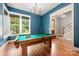 Billiard room featuring a light fixture and an adjacent entranceway to the rest of the home at 1620 Arnold Dr, Charlotte, NC 28205