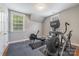 Home gym featuring rowing machine, elliptical machine and wood-look flooring at 1620 Arnold Dr, Charlotte, NC 28205