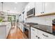 Bright kitchen featuring stainless steel appliances, white cabinets, and granite countertops at 1620 Arnold Dr, Charlotte, NC 28205