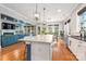 A kitchen island with a granite countertop overlooks a Gathering room with fireplace and blue couch at 1620 Arnold Dr, Charlotte, NC 28205