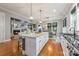 Open concept kitchen with a large island, pendant lighting, and a view of the dining and living areas at 1620 Arnold Dr, Charlotte, NC 28205