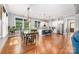 Open-concept kitchen with hardwood floors, white cabinetry, stainless steel appliances, and adjacent dining area at 1620 Arnold Dr, Charlotte, NC 28205