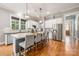 Spacious kitchen with an island, stainless steel appliances, and a window, featuring hardwood floors at 1620 Arnold Dr, Charlotte, NC 28205