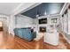Gathering room with cozy fireplace and built-in bookshelves, and hardwood floors at 1620 Arnold Dr, Charlotte, NC 28205