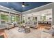 Spacious living room with large windows, comfortable seating, hardwood floors, and an open view to the backyard at 1620 Arnold Dr, Charlotte, NC 28205