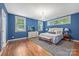 Serene main bedroom featuring hardwood floors, abundant natural light, and stylish decor at 1620 Arnold Dr, Charlotte, NC 28205