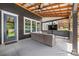 Inviting outdoor covered patio area with plush seating and TV for year-round entertainment at 1620 Arnold Dr, Charlotte, NC 28205