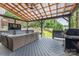 Stylish outdoor covered patio with comfortable seating, grill and TV, perfect for entertaining at 1620 Arnold Dr, Charlotte, NC 28205