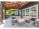 Comfortable outdoor living on the patio featuring an outdoor sectional, fan, and grilling area at 1620 Arnold Dr, Charlotte, NC 28205