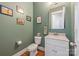 Updated powder room with marble vanity, framed mirror, and modern fixtures at 1620 Arnold Dr, Charlotte, NC 28205