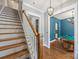 Elegant staircase with hardwood steps and white railings, leading to an upstairs landing at 1620 Arnold Dr, Charlotte, NC 28205