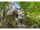 Secluded backyard with stone wall, wrought iron gate, and lush greenery for privacy and charm at 1625 Bibury Ln, Charlotte, NC 28211