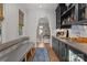 Inviting bar area with black cabinetry, marble countertops, a seating area and view to office space at 1625 Bibury Ln, Charlotte, NC 28211