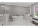 Elegant bathroom featuring butterfly wallpaper, a standalone tub, dual vanities and marble floors at 1625 Bibury Ln, Charlotte, NC 28211