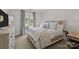 Bright bedroom features a cozy bed with soft linens, a large window, and comfortable furnishings at 1625 Bibury Ln, Charlotte, NC 28211