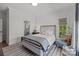 Cozy bedroom with natural light, hardwood floors, and decorative rug at 1625 Bibury Ln, Charlotte, NC 28211