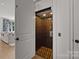 Interior shot of an elevator with wood paneling and accordion gate for easy access between floors at 1625 Bibury Ln, Charlotte, NC 28211