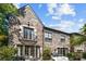 Stunning stone home with balcony, large windows, and a well-manicured outdoor seating area at 1625 Bibury Ln, Charlotte, NC 28211