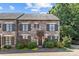 Charming stone townhouse featuring a well-manicured lawn and striking wood shutters at 1625 Bibury Ln, Charlotte, NC 28211