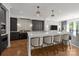 Modern kitchen with marble countertops, state-of-the-art appliances, and herringbone floors at 1625 Bibury Ln, Charlotte, NC 28211