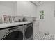 Well-organized laundry room with modern appliances, ample storage, and stylish tile flooring at 1625 Bibury Ln, Charlotte, NC 28211