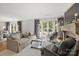 Inviting living room featuring a cozy fireplace and access to the outdoor patio at 1625 Bibury Ln, Charlotte, NC 28211
