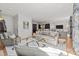 Bright living room with hardwood floors, white rug, modern furniture, and view to the kitchen at 1625 Bibury Ln, Charlotte, NC 28211