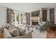 Comfortable living room with a stone fireplace, neutral colors, and french doors at 1625 Bibury Ln, Charlotte, NC 28211