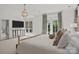 Spacious main bedroom with a TV, hardwood floors and bright natural light from windows at 1625 Bibury Ln, Charlotte, NC 28211