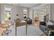 Comfortable office with neutral tones and hardwood floors, plus view to sitting area at 1625 Bibury Ln, Charlotte, NC 28211