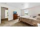 A cozy bedroom with neutral walls and carpet features an antique dresser and TV at 16453 Nc Hwy 73 Hwy, Albemarle, NC 28001